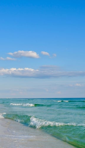 Emerald Coast beach in September, clean white sand and turquoise water
