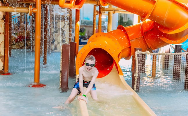 Boy on water slide at water park