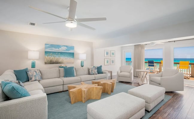 Beach chairs and turquoise umbrella on white sand at the Gulf